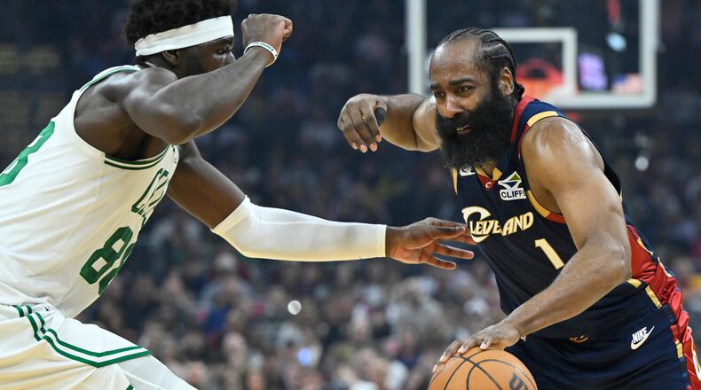 Cleveland Cavaliers guard James Harden (1) dribbles beside Boston Celtics center Neemias Queta in the first half of an NBA basketball game in Cleveland, Sunday, March 8, 2026. (AP Photo/David Richard)