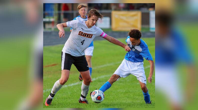Shawnee High School senior Jake Young and Northwestern sophomore Bryant Burton tussle for the ball during their game at Taylor Field earlier this season. Michael Cooper/CONTRIBUTED