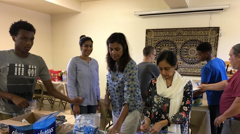 Members of the Miami Valley Islamic Assn. and Champion City Vineyard Church prepare hygiene packs to be donated to the Springfield Soup Kitchen on Sunday, June 3 at Masjid Al-Madina Mosque. Photo by Brett Turner