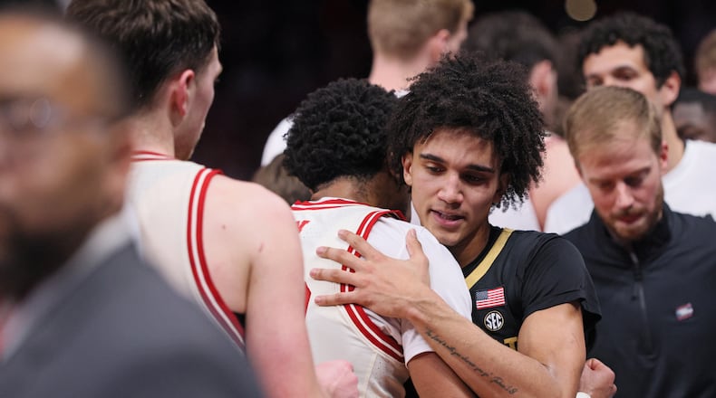 Vanderbilt guard Tyler Tanner, center right, hugs Nebraska guard Jamarques Lawrence, center left, after a game in the second round of the NCAA college basketball tournament, Saturday, March 21, 2026, in Oklahoma City. (AP Photo/Nate Billings)