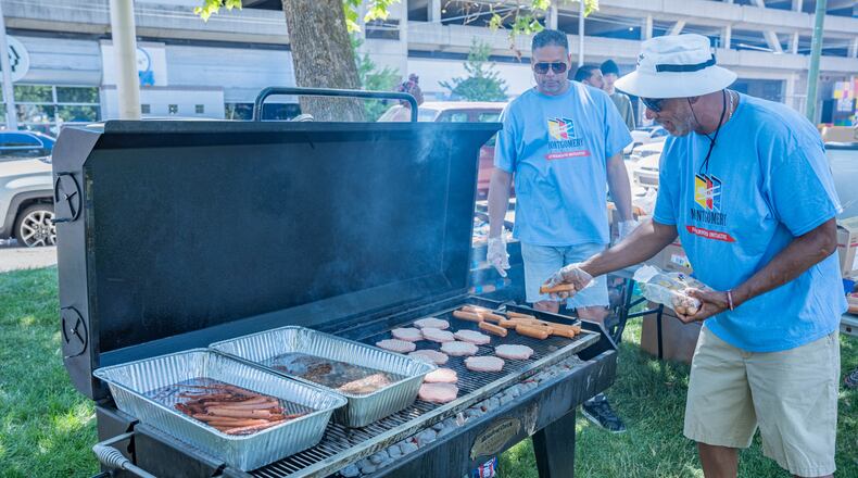 Volunteers man the grill at the Celebrate Fatherhood Picnic at Levitt Pavilion in downtown Dayton.