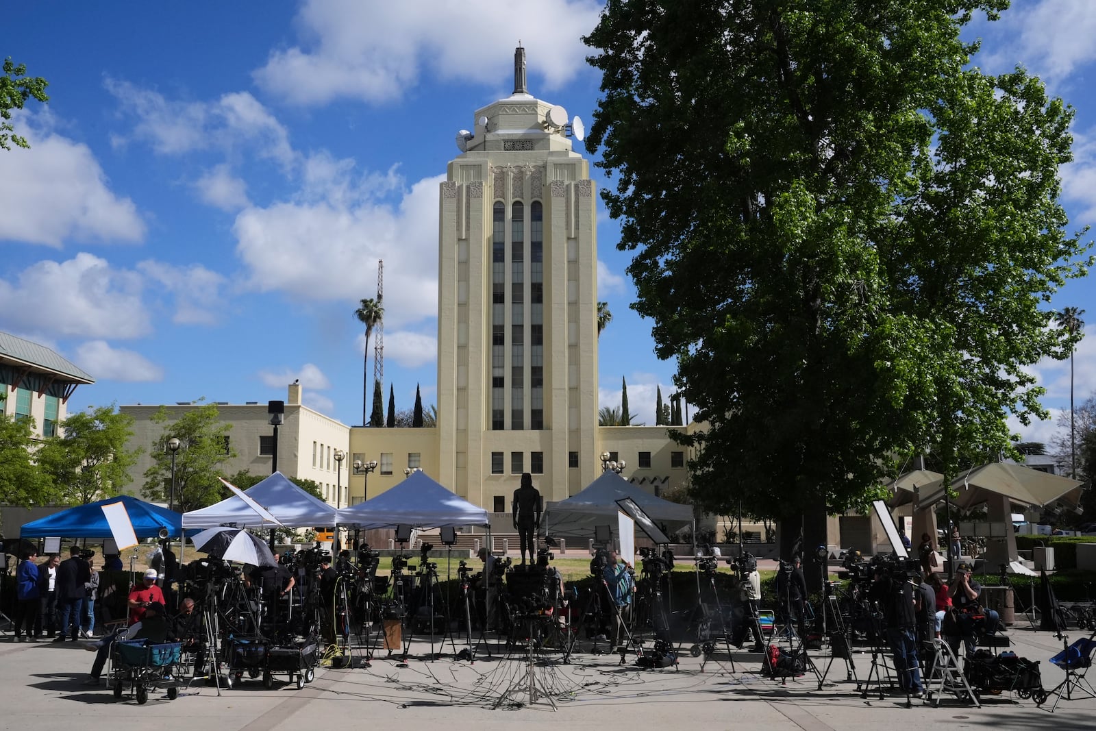 Media stage outside the Van Nuys Courthouse for a hearing in the case of Erik and Lyle Menendez Tuesday, May 13, 2025, in Los Angeles. (AP Photo/Damian Dovarganes)