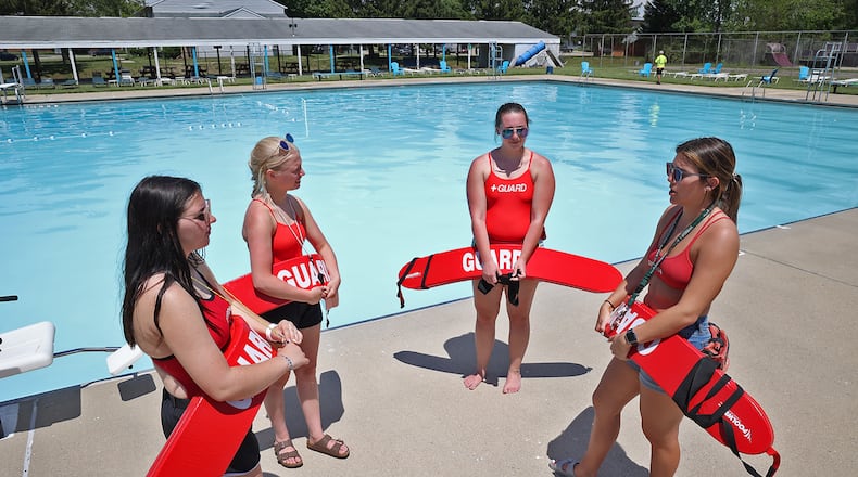 The lifeguards at the New Carlisle pool, Riayn Lowry Erica Kelly Michelle Murray and Julia Randenburg have a safety meeting Friday at the pool. BILL LACKEY/STAFF