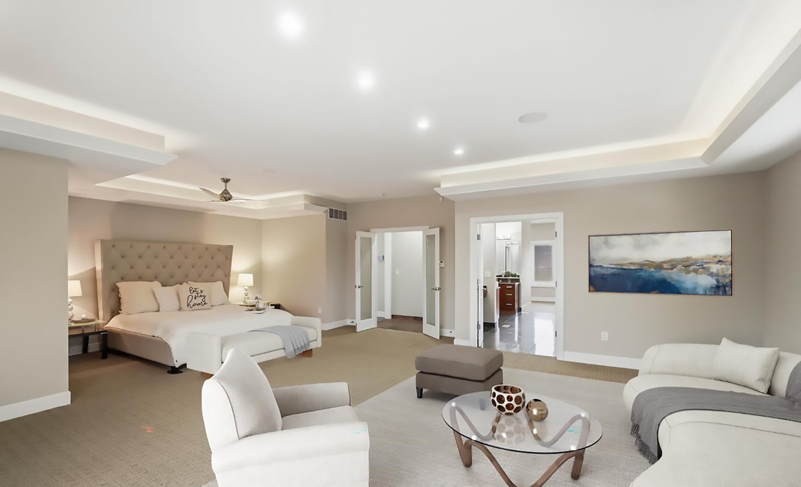 The first floor primary bedroom suite has carpeting, a lighted tray ceiling, recessed lighting and a ceiling fan. It has an ensuite bathroom and a double size walk in closet. CONTRIBUTED