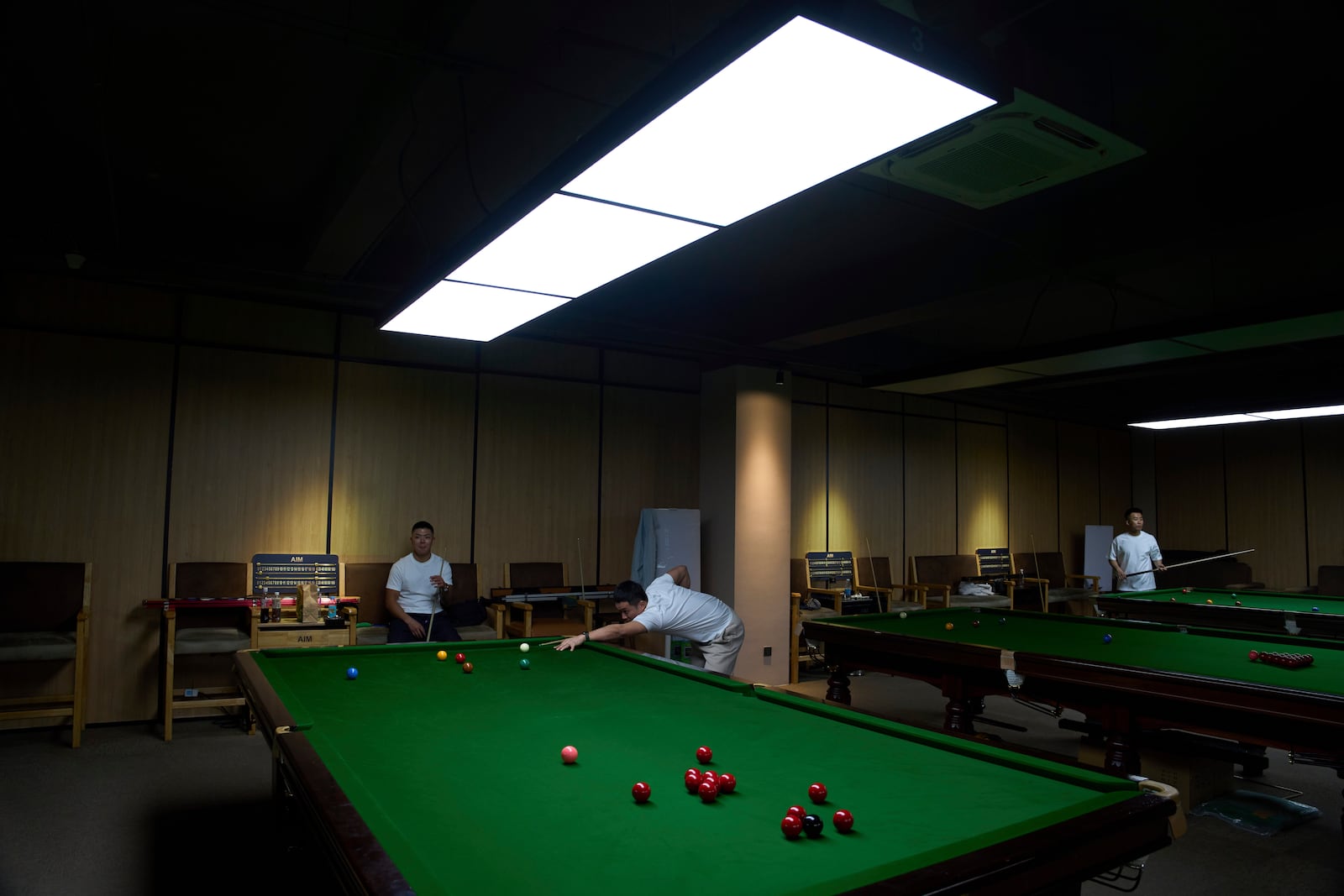 Snooker fans play a game at the Beijing Xinrui Billiard Academy in Beijing, Tuesday, May 6, 2025. (AP Photo/Ng Han Guan)