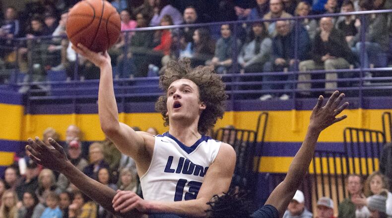 Emmanuel Christian’s Casey Swank shoots over Legacy Christian’s Keano Hammerstrom during Friday night’s game at Emmanuel in Springfield. Swank scored 14 points to help lead ECA to a 75-60 victory. Jeff Gilbert/CONTRIBUTED