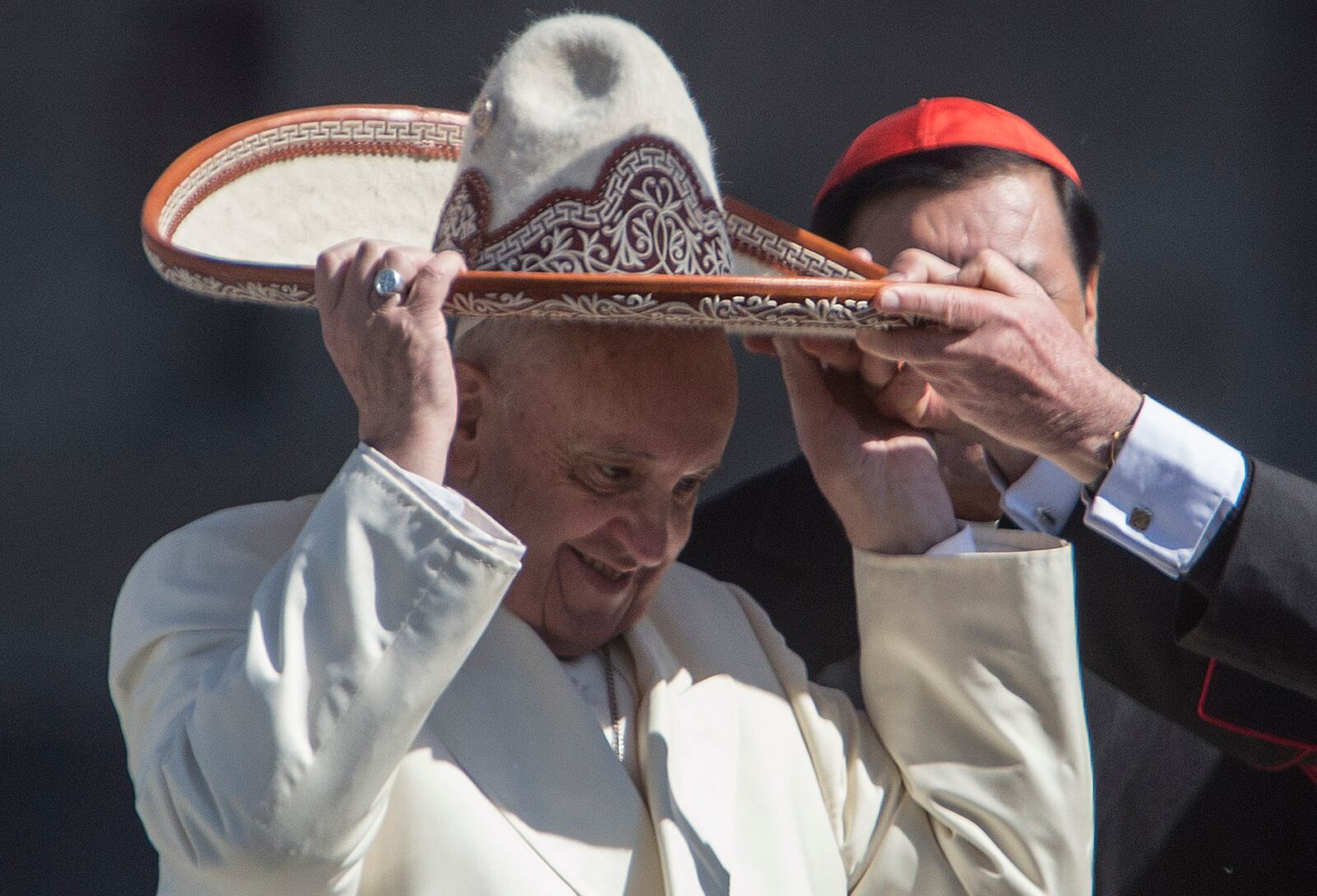FILE - Pope Francis dons a Mexican charro style sombrero, in Mexico City's main square, the Zocalo, Saturday, Feb. 13, 2016. (AP Photo/Christian Palma, file)