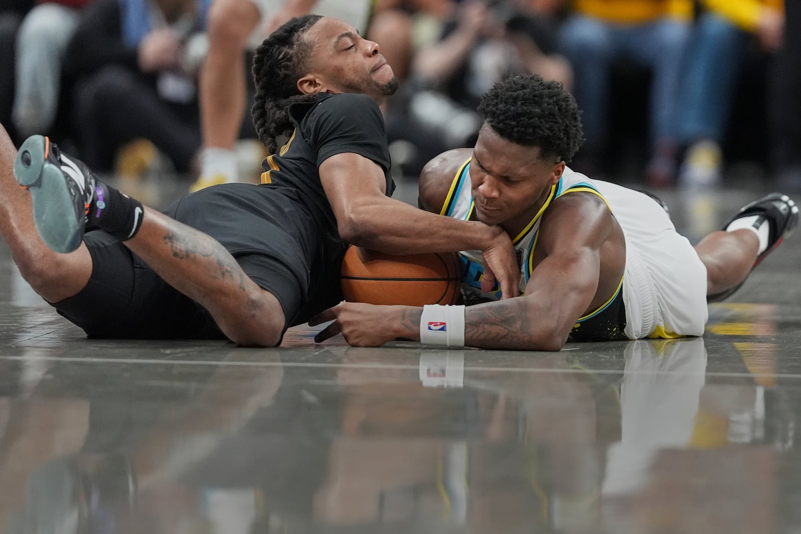 Cleveland Cavaliers guard Darius Garland, left, and Indiana Pacers guard Bennedict Mathurin, right, battle for a loose ball during the second half of Game 3 in the Eastern Conference semifinals of the NBA basketball playoffs in Indianapolis, Friday, May 9, 2025. (AP Photo/Michael Conroy)