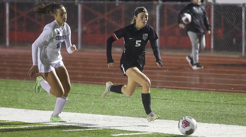 Greenon High School senior Hallie Gilley is chased by Cincinnati Country Day's Alessandra Garcia-Altuve during their Division III district final match at Trotwood-Madison High School on Thursday, Oct. 29. The Nighthawks won 7-0. CONTRIBUTED PHOTO BY MICHAEL COOPER