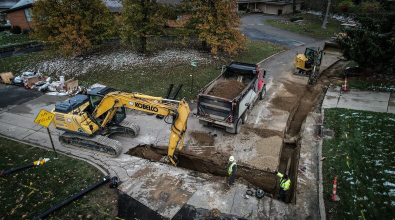 Workers replace old water pipes near the intersection of Folsom Drive and Knollview in Harrison Twp. Water distributors in southwest Ohio said rising maintenance and operating costs are factors in customer water rate increases. JIM NOELKER/STAFF