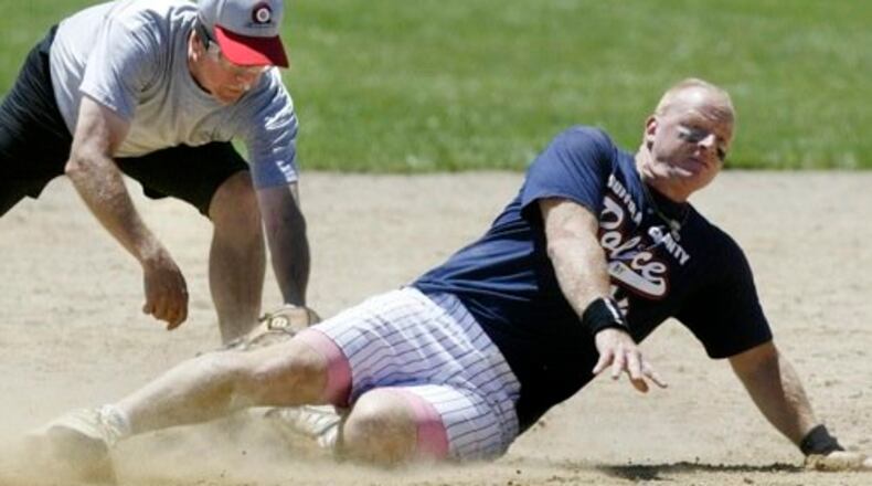 A Suffolk County Police baserunner gets to second under the Dayton Metro Gold squad's Jim Roepken, left, during the Master Division championship game Sunday, July 13, in the 37th Annual Dayton Police National Softball Championship tournament at Kettering Fields. The two teams ended up playing each other three times, splitting the first two before Suffolk County won the final, 13-2.