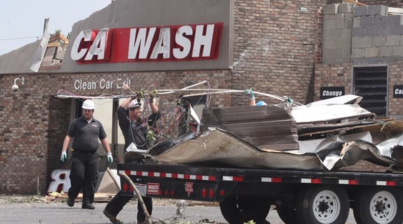 Cleanup begins at Mike’e Car Wash in Beavercreek. BILL LACKEY / STAFF