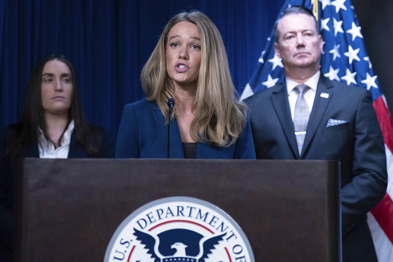 DHS Assistant Secretary for Public Affairs Tricia McLaughlin flanked by Deputy director of U.S. Immigration and Customs Enforcement Madison Sheahan, left, and Acting director of U.S. Immigration and Customs Enforcement Todd Lyons, speaks during a news conference at ICE Headquarters, in Washington, Wednesday, May 21, 2025. (AP Photo/Jose Luis Magana)