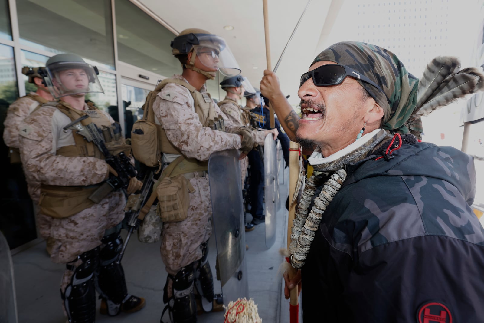 Protesters confront Marines outside the Federal Building on Friday, July 4, 2025 in Los Angeles. (AP Photo/Jill Connelly)