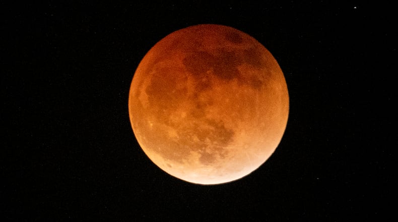 Light shines from a total lunar eclipse during the first blood moon of the year, in Temple City, Calif., Sunday, May 15, 2022. (AP Photo/Ringo H.W. Chiu)