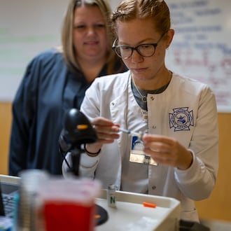 Sarah Hagenbuch (back), Clark State registered nursing associate professor, uses Assist AI to support teaching and provide additional time for individualized instruction and student support. CONTRIBUTED