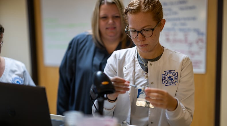 Sarah Hagenbuch (back), Clark State registered nursing associate professor, uses Assist AI to support teaching and provide additional time for individualized instruction and student support. CONTRIBUTED