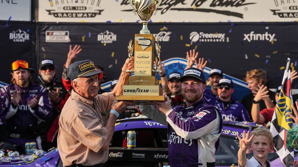 Tyler Reddick, center right, celebrates with his team in Victory Lane after winning a NASCAR Cup Series auto race, Sunday, March 22, 2026, in Darlington, S.C.(AP Photo/Matt Kelley)