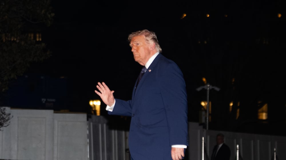 President Donald Trump waves on the South Lawn as he returns to the White House following a trip to Florida, Monday, March 9, 2026, in Washington. (AP Photo/Allison Robbert)