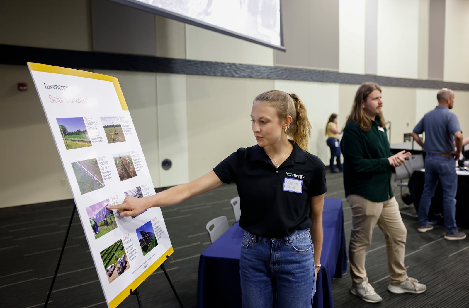 Dagmara Sobolak, center, renewable staff engineer at Invenergy, shares the process of building a solar panel during a public information meeting held by Invenergy on Tuesday, July 8, 2025, at Hollenebeck Center to get feedback on the 180-megawatt Sloopy Solar Energy Center. JOSEPH COOKE/STAFF