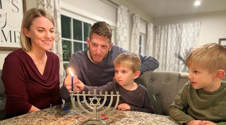 The Solovey family, Katie, Tal, Liam and Ben, lights the first candle in the Hanukkah menorah. The Festival of Lights started Sunday. SUBMITTED