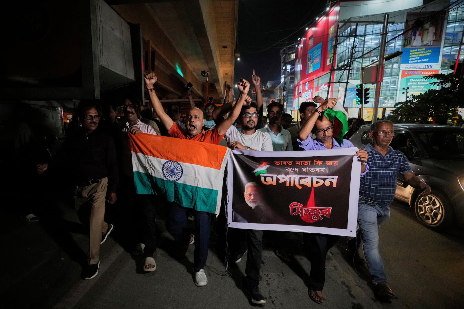 People holding Indian national flags rally's in support of the Indian Army as they celebrate the success of 'Operation Sindoor', in Guwahati, India, Thursday, May 8, 2025. (AP Photo/Anupam Nath)