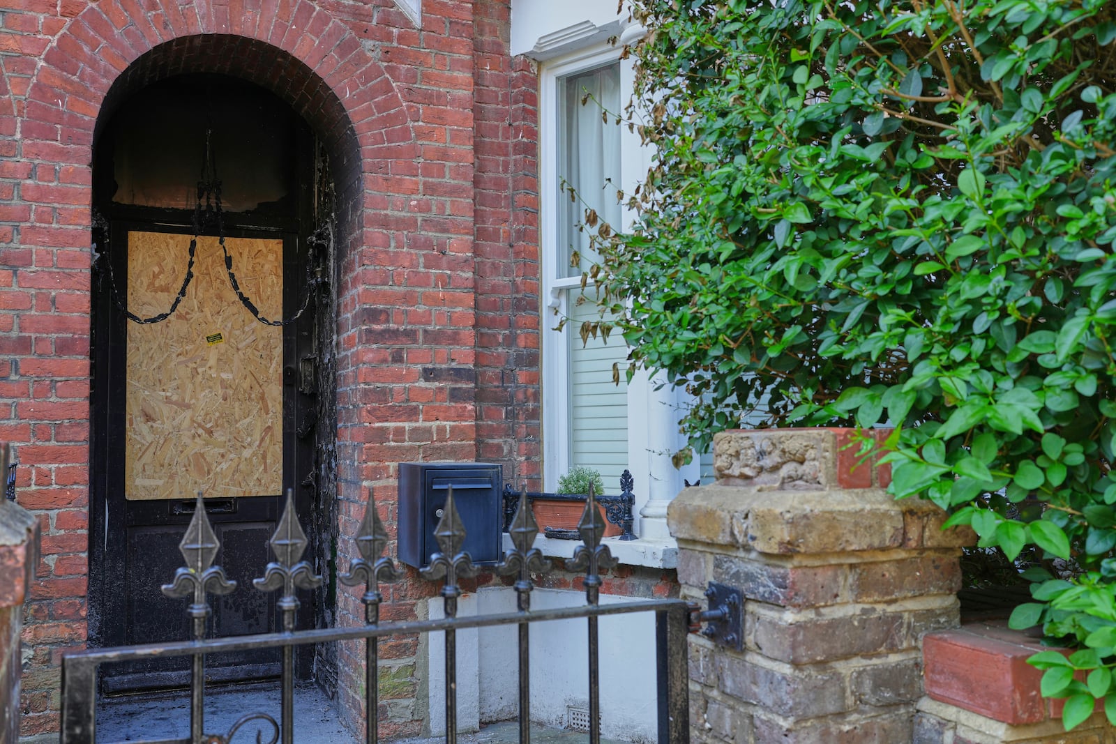 Fire damage is seen in the doorway of a house belonging to British Prime Minister Keir Starmer in Kentish Town in London, Tuesday, May 13, 2025. (AP Photo/Kirsty Wigglesworth)