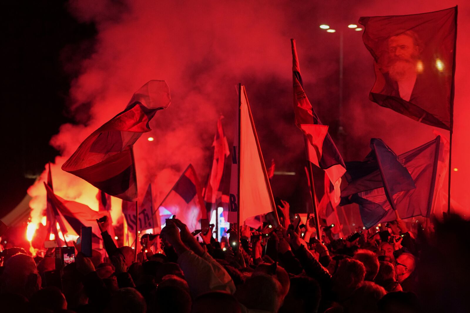 Supporters of Serbia's President Aleksandar Vucic gather during a rally, apparently designed to counter student-led gatherings, in Belgrade, Serbia, Saturday, April 12, 2025. (AP Photo/Darko Vojinovic)