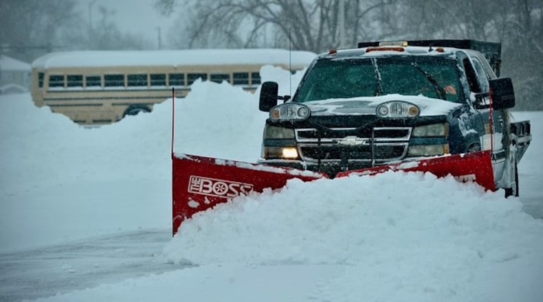 A snow plow clears the lot at the Fairborn YMCA early Sunday, Jan. 25, 2026. By 11 a.m. Sunday the Springfield and Dayton region had seen nearly 12 inches of snow, with more coming. MARSHALL GORBY/STAFF