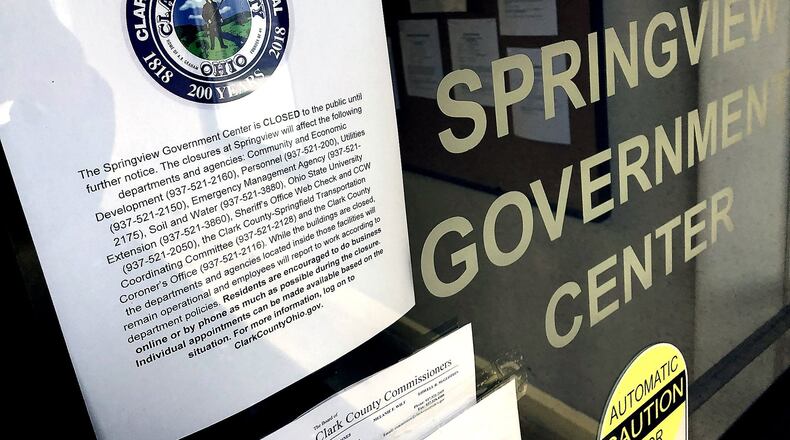 A sign on the door of the Springview Government Center explains why the Clark County building is closed Tuesday. BILL LACKEY/STAFF