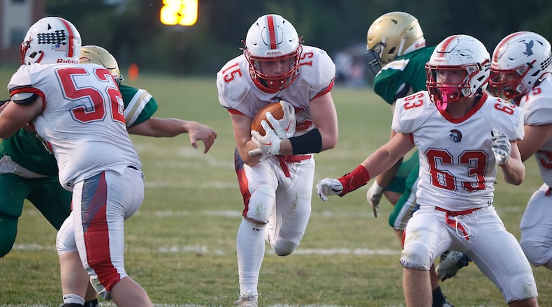 Southeastern's Hayden Davis rushes through a hole in the Catholic Central defensive line for a Trojan's touchdown. BILL LACKEY/STAFF