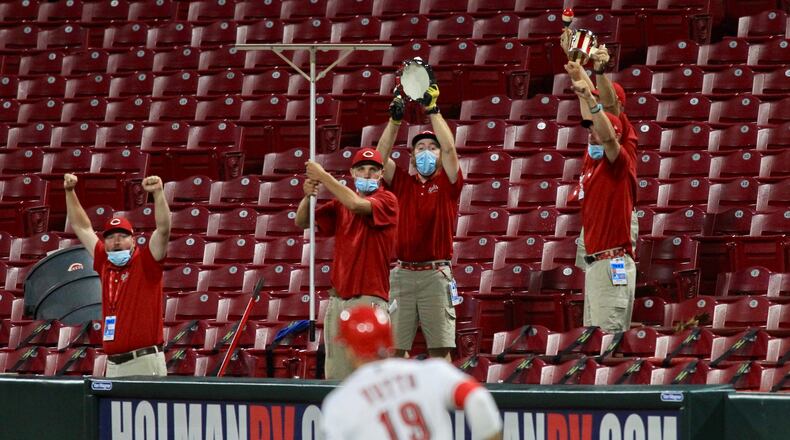Joey Votto, of the Reds, rounds first base after a home run in the sixth inning against the Indians as the grounds crew cheers on Monday, Aug. 3, 2020, at Great American Ball Park in Cincinnati. David Jablonski/Staff