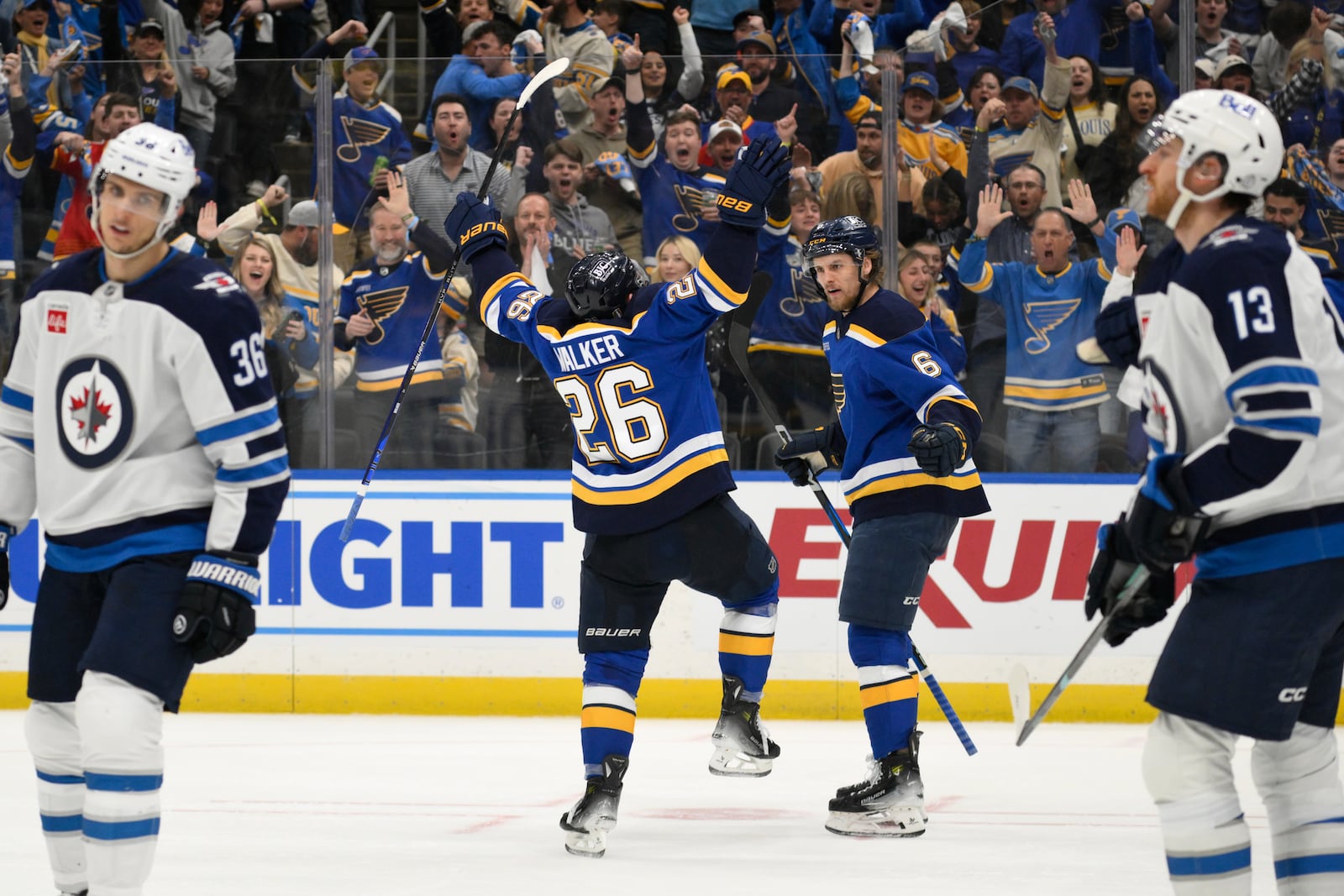 St. Louis Blues left wing Nathan Walker (26) reacts with defenseman Philip Broberg (6) after scoring against the Winnipeg Jets during the second period in Game 6 of an NHL hockey first-round playoff series Friday, May 2, 2025, in St. Louis. (AP Photo/Jeff Le)