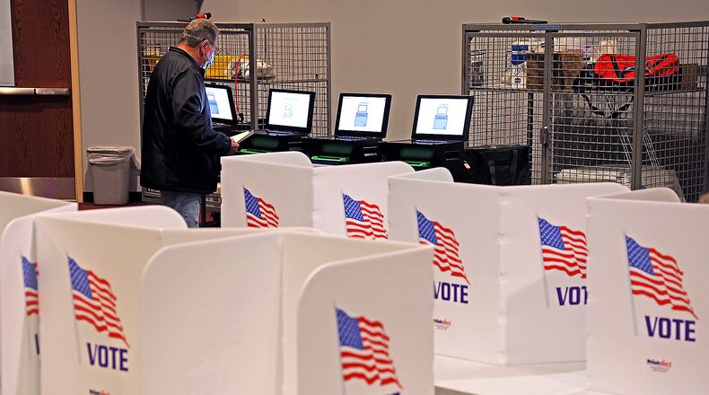 A man casts her vote for Judge Tuesday at First Christian Church on Middle Urbana Road in Clark County . BILL LACKEY/STAFF