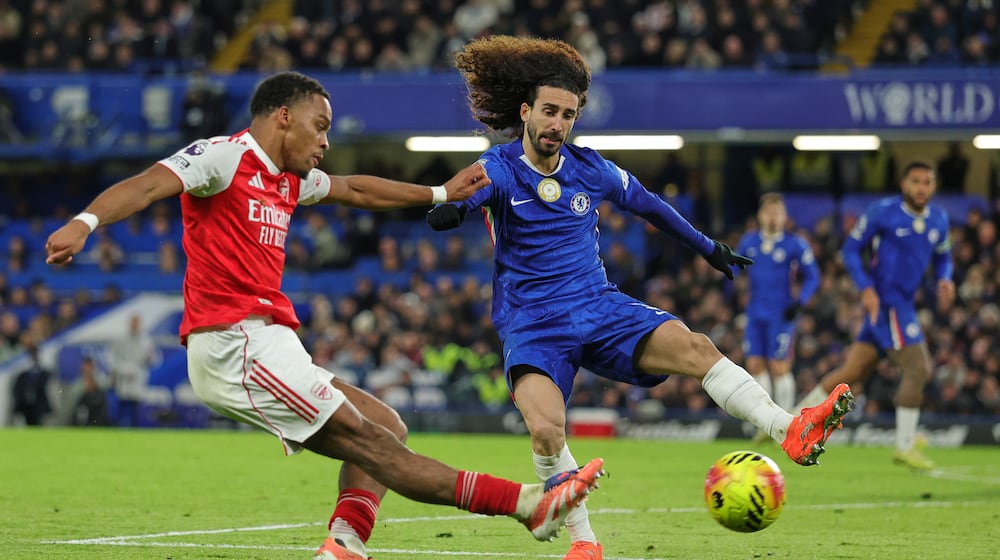 Arsenal's Jurrien Timber, left, kicks the ball ahead of Chelsea's Marc Cucurella during the English Premier League soccer match between Chelsea and Arsenal in London, England, Sunday, Nov. 30, 2025. (AP Photo/Ian Walton)
