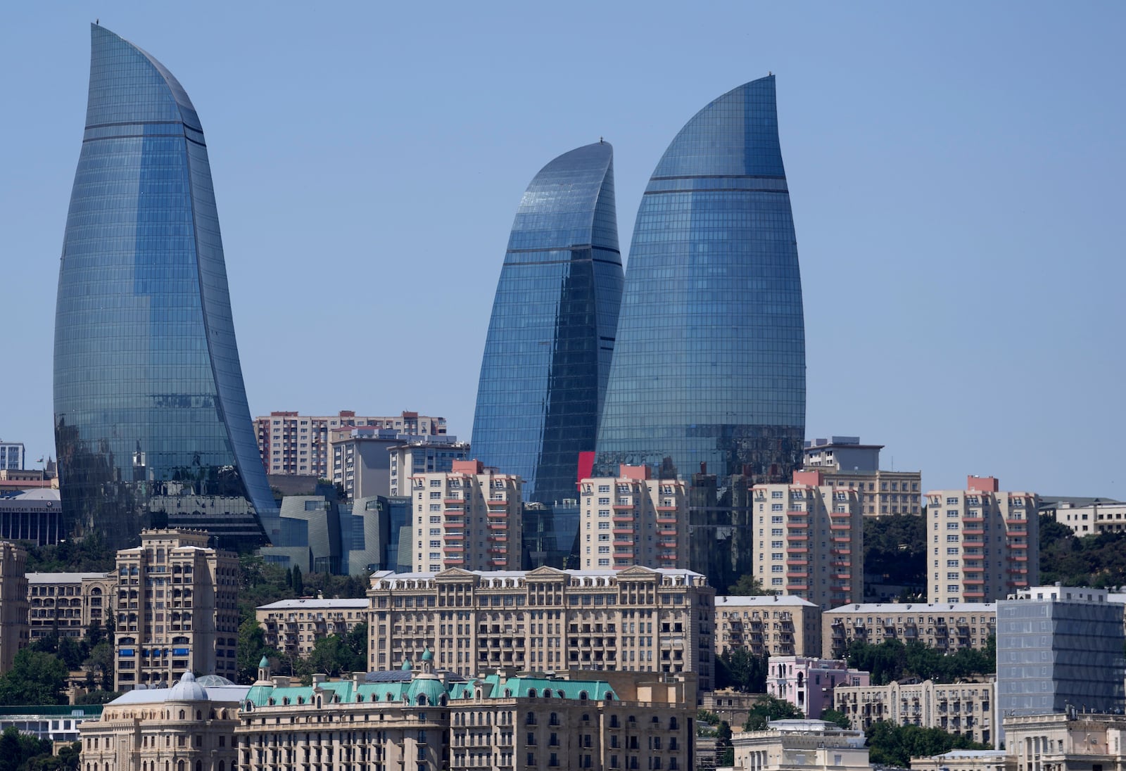 FILE - The Old City stands with the Flame Towers skyscrapers in background in Baku, Azerbaijan, June 13, 2021. (AP Photo/Darko Vojinovic, File)