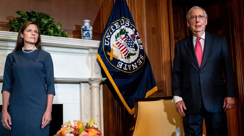 FILE — Judge Amy Coney Barrett, President Donald Trump's nominee for the Supreme Court, meets with Senate Majority Leader Mitch McConnell (R-Ky.) on Capitol Hill in Washington, Sept. 29, 2020. The confirmation of Barrett caps an enduring achievement that McConnell could not even have imagined four years ago: the confirmation of three Supreme Court justices, the appointment of fifty-three appeals court judges, and scores of new young conservative judges presiding on the district courts — all delivered under his close supervision and direction. (Erin Schaff/The New York Times)