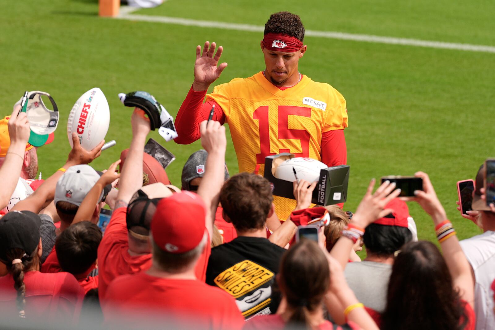 Kansas City Chiefs quarterback Patrick Mahomes greets fans at NFL football training camp Tuesday, July 22, 2025, in St. Joseph, Mo. (AP Photo/Charlie Riedel)