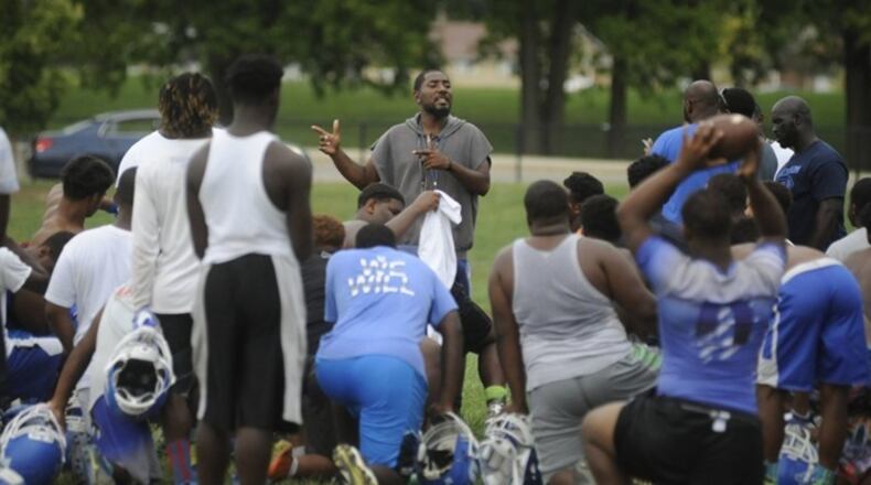 Dunbar football coach Darran Powell (middle) oversees practice last season. MARC PENDLETON / STAFF