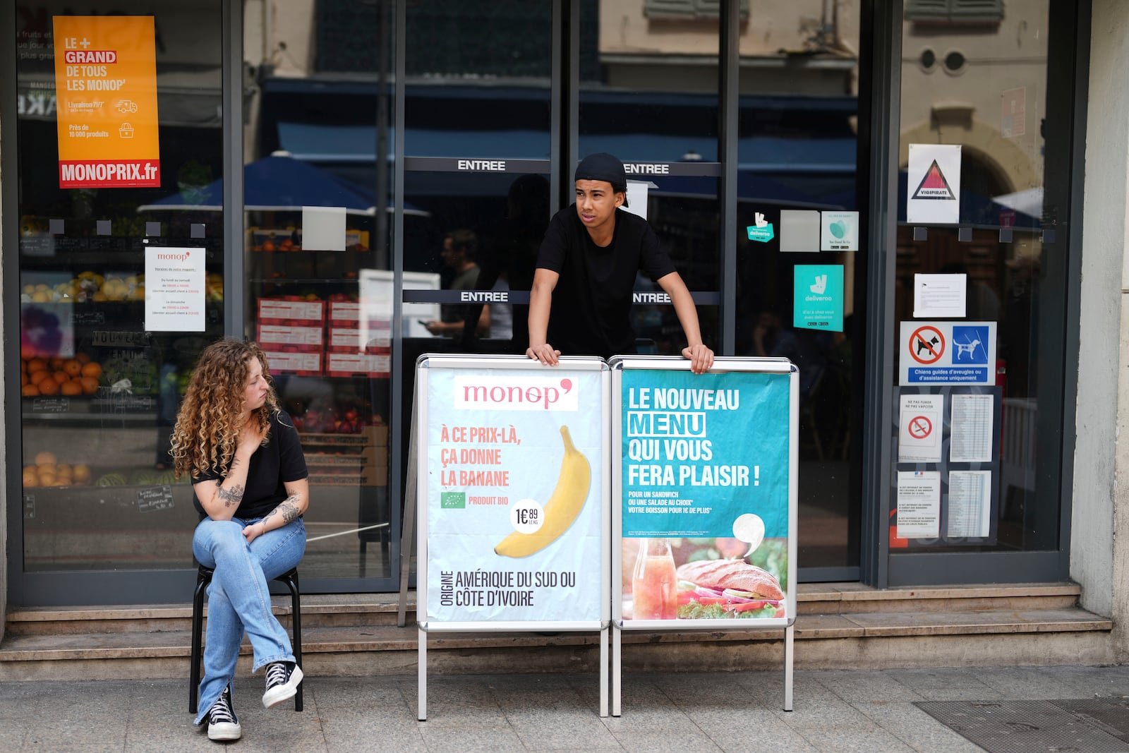 Supermarket workers stand outside a closed shop due to a electricity outage in Cannes, southern France, Saturday, May 24, 2025. (AP Photo/Natacha Pisarenko)