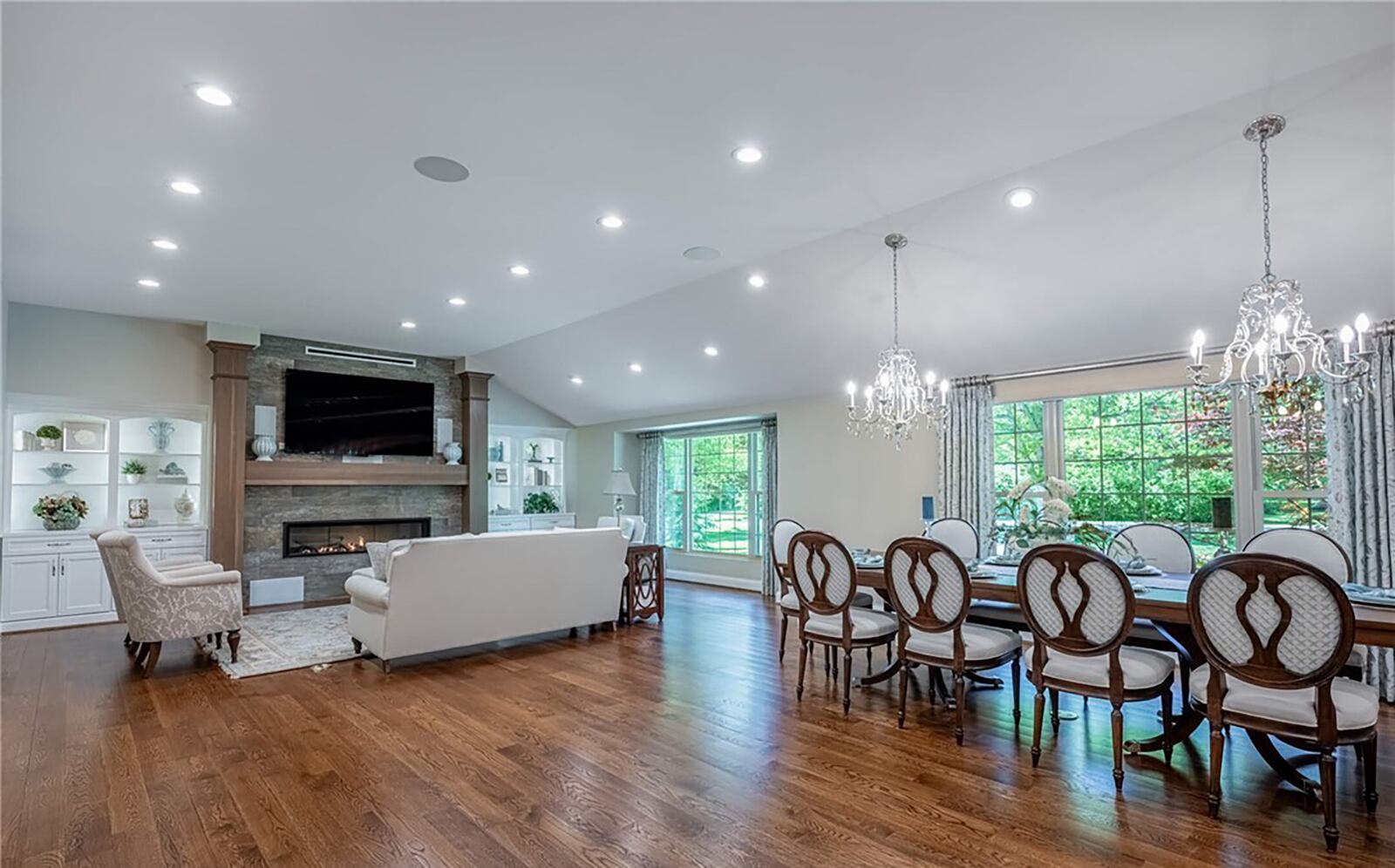 the open concept living/dining and kitchen areas have hardwood flooring, vaulted ceilings and recessed lighting. There is a gas fireplace in the living room.