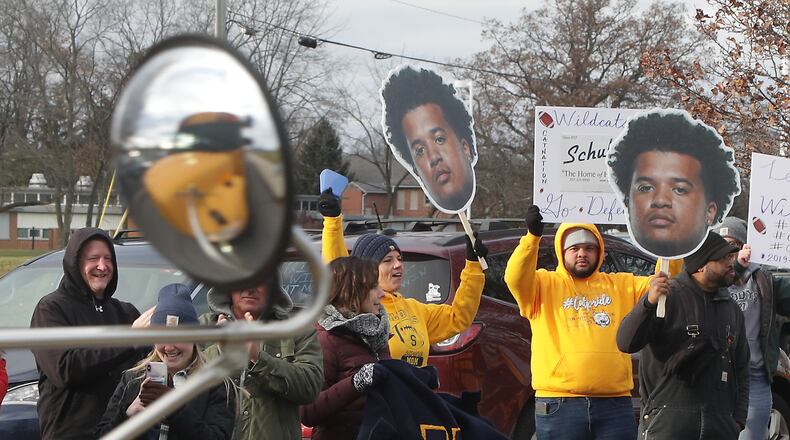 Springfield fans cheer for the Wildcats football team as their buses leave for their state semifinal game last Friday. BILL LACKEY/STAFF