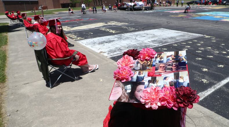 The Triad High School class of 2020 marched around the parking lot of the high school as they participated in a social distanced commencement ceremony in May. BILL LACKEY/STAFF