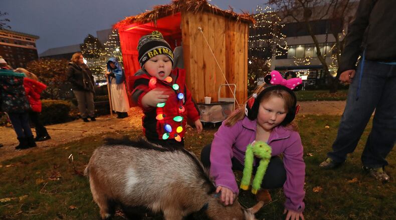 Joshua Hennis, 3, and his sister, Shellie, 7, pet a goat that was part of the live nativity scene at the 2018 Holiday in the City Festival. BILL LACKEY/STAFF