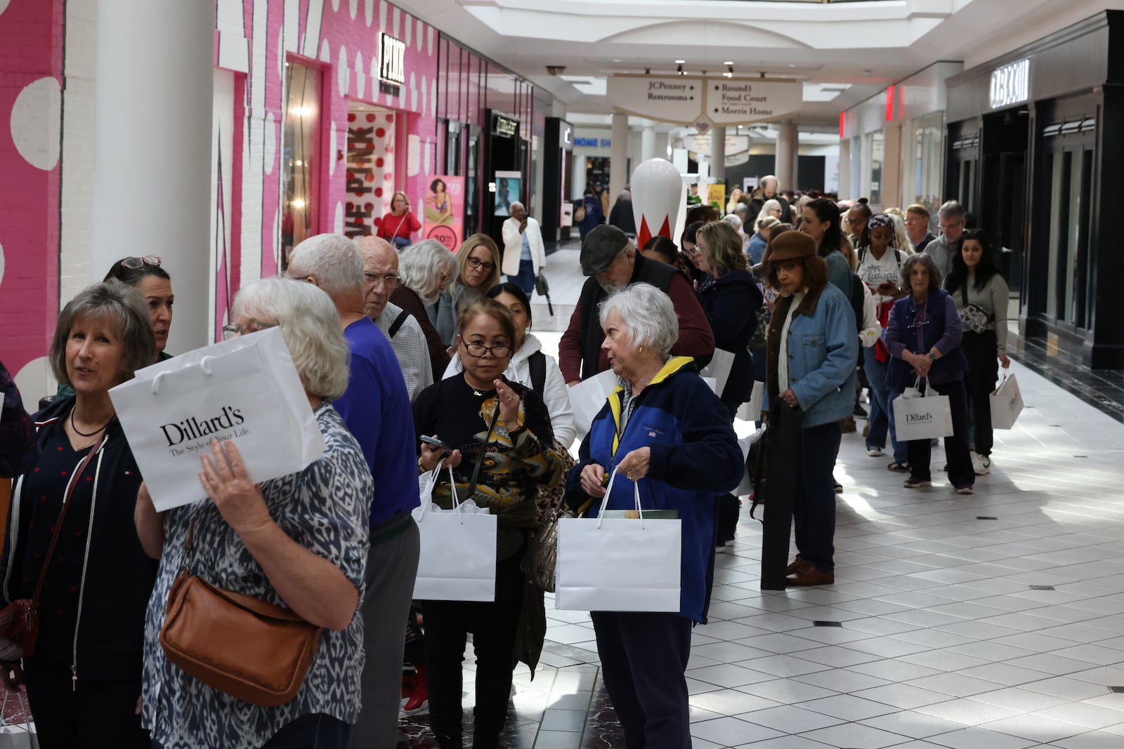 Shoppers gather and celebrate during the grand opening of Dillard’s at the Mall at Fairfield Commons on Thursday, March 19 in Beavercreek. The new store opened following a ribbon-cutting ceremony and featured giveaways, promotions and special events for customers. BRYANT BILLING / STAFF