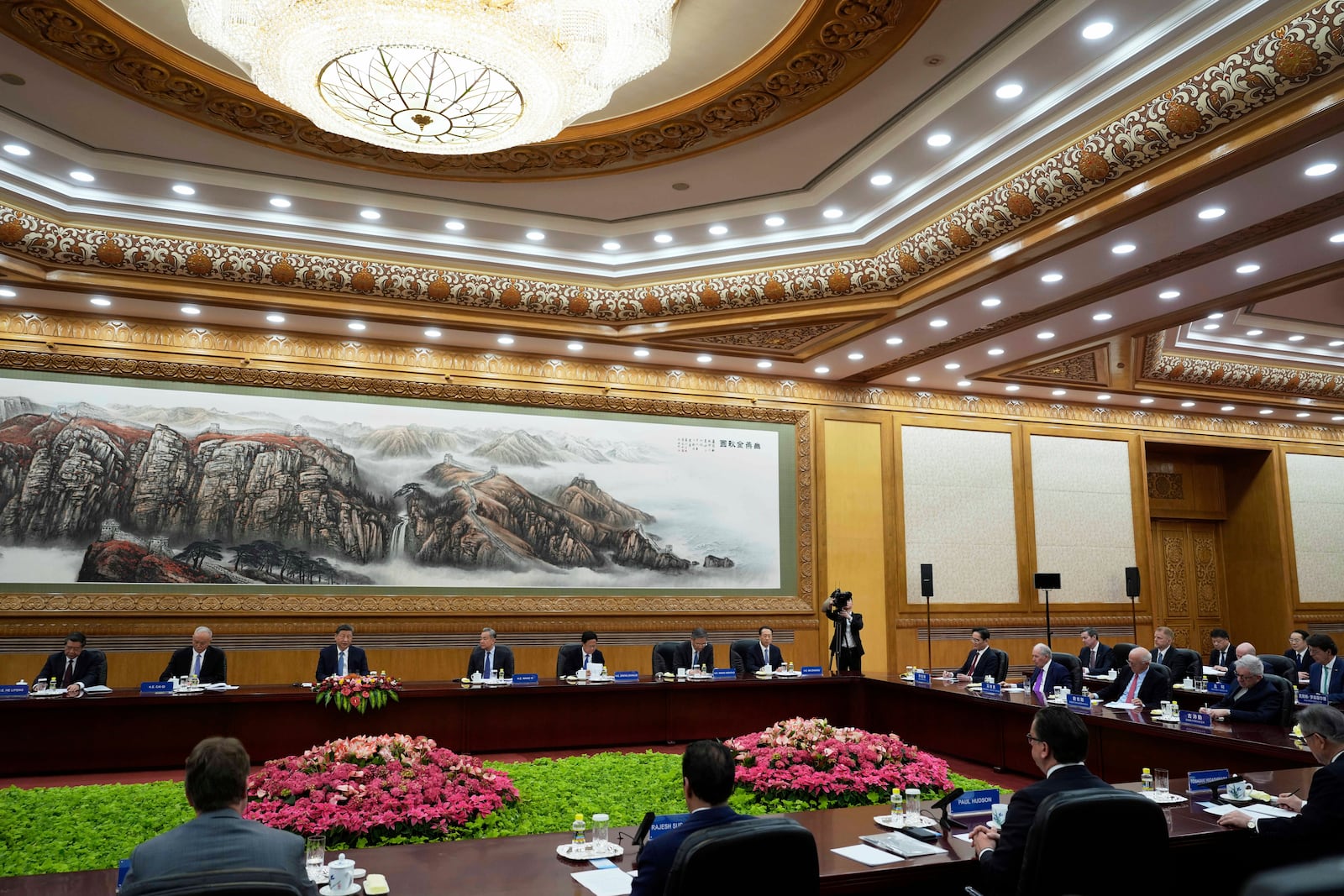 Chinese President Xi Jinping, third left, and Foreign Minister Wang Yi, fourth left, meet an international business representatives during an event at the Great Hall of the People in Beijing on Friday, March 28, 2025. (AP Photo/Ng Han Guan)
