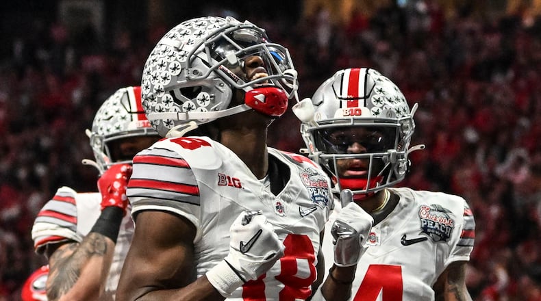 Ohio State wide receiver Marvin Harrison Jr. (18) celebrates his touchdown catch against Georgia during the first half of the Peach Bowl NCAA college football semifinal playoff game, Saturday, Dec. 31, 2022, in Atlanta. (AP Photo/Danny Karnik)