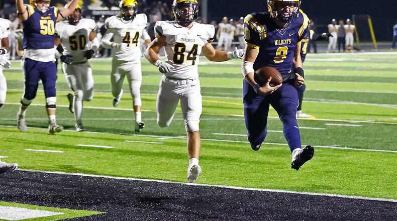 Springfield quarterback Bryce Schondelmyer leaps into the end zone to score a touchdown for the Wildcats during the playoff game against Centerville. BILL LACKEY/STAFF