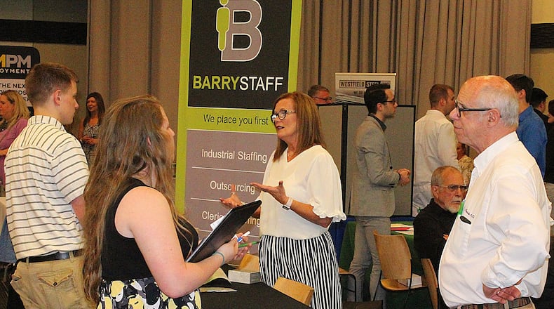 Employers and applicants talk at the eighth annual Ohio Means Jobs and Clark County job Fair. JEFF GUERINI/STAFF