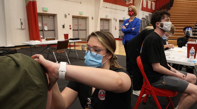 Wittenberg University is encouraging individuals eligible to schedule an appointment for the COVID-19 booster shot. Here, nursing student Camille Odle gave a student a COVID-19 vaccination earlier this year. BILL LACKEY/STAFF